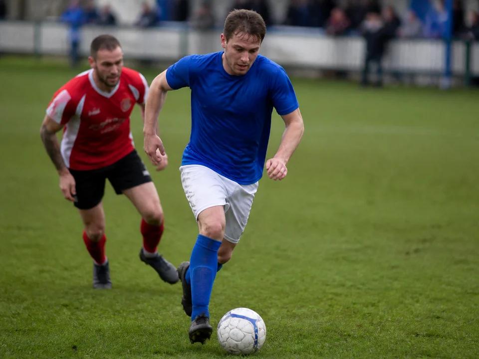 Football player dribbling the ball during a match