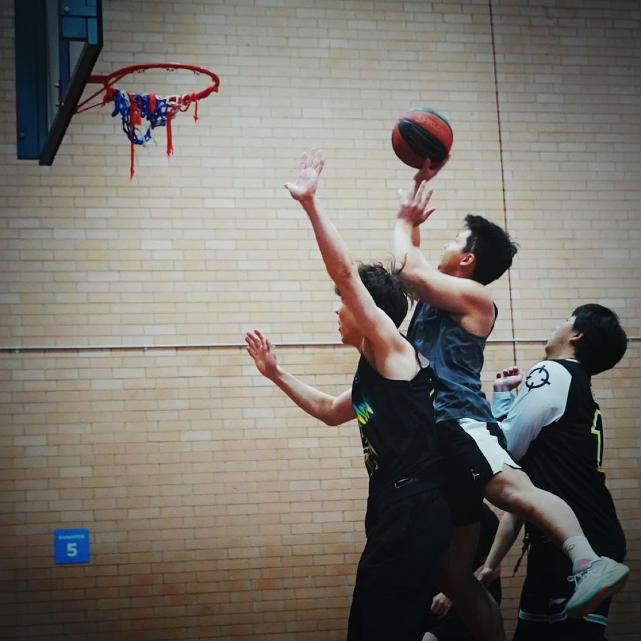 Basketball players on an indoor court